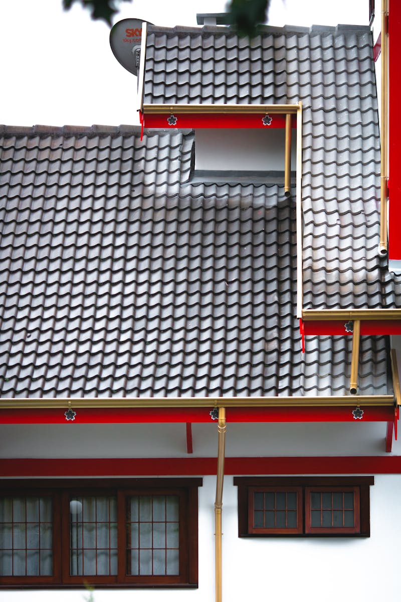 Photo by Athena Sandrini An architectural shot of a house exterior featuring a contemporary, tiled roof design.